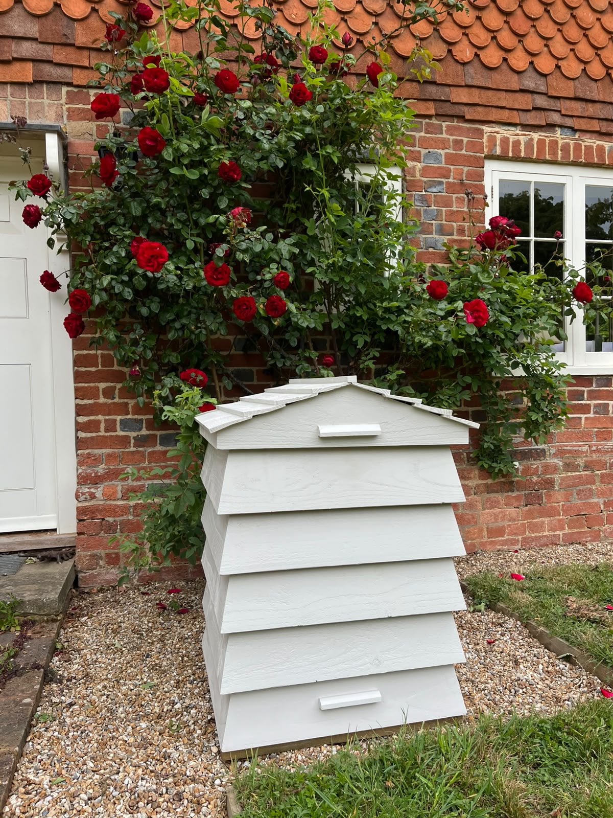 Bee Tidy parcel box hive showing its timber beehive shape and weatherproof finish