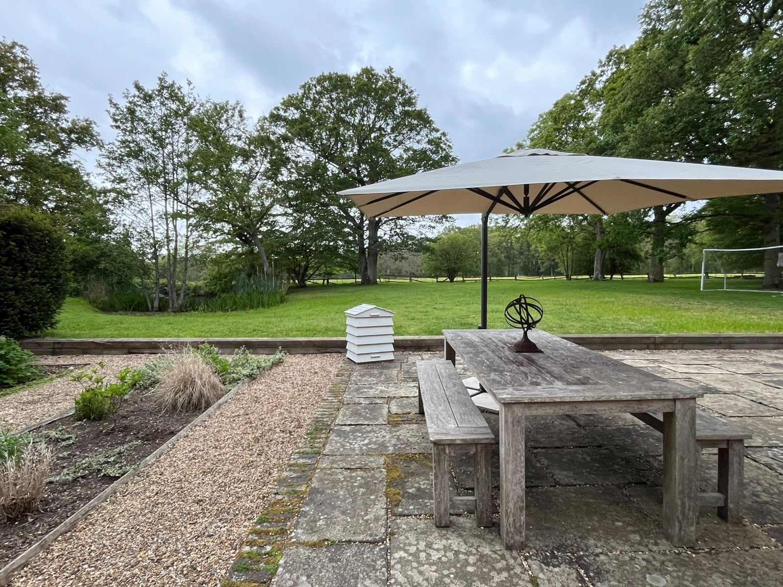 Patio Hive used as timber storage on an outdoor terrace